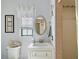 Bright bathroom featuring a white vanity, toilet, and tiled walk-in shower at 28416 Tammi Dr, Tavares, FL 32778