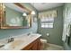 Bright bathroom with double vanity, large mirror, and decorative wall art at 28416 Tammi Dr, Tavares, FL 32778