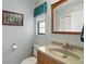 Bathroom featuring a vanity with a sink, toilet, framed art, and a window for natural light at 28416 Tammi Dr, Tavares, FL 32778