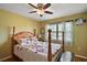 Cozy bedroom with a patterned quilt, ceiling fan and natural light at 28416 Tammi Dr, Tavares, FL 32778