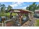 Covered boat dock on the water with chairs, ready for relaxation and waterfront enjoyment at 28416 Tammi Dr, Tavares, FL 32778