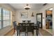 Formal dining room featuring a wooden table set and a view into the kitchen at 28416 Tammi Dr, Tavares, FL 32778