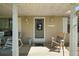 Charming front porch with a rocking chair, welcome mat, and decorative door at 28416 Tammi Dr, Tavares, FL 32778