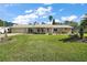 Charming single-story home with a well-manicured lawn and inviting front porch at 28416 Tammi Dr, Tavares, FL 32778