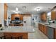 Well-lit kitchen with stainless steel appliances, custom cabinets, and tile flooring at 28416 Tammi Dr, Tavares, FL 32778