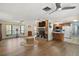 A spacious living room with a brick fireplace and an open layout to the kitchen at 28416 Tammi Dr, Tavares, FL 32778