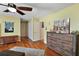 Spacious main bedroom with wood floors and access to closet and ensuite bathroom at 28416 Tammi Dr, Tavares, FL 32778