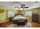 Comfortable main bedroom featuring a ceiling fan, natural light, and hardwood flooring at 28416 Tammi Dr, Tavares, FL 32778