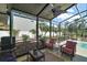 Screened patio with outdoor seating, ceiling fan, and a view of the backyard landscaping at 28416 Tammi Dr, Tavares, FL 32778