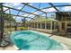 Backyard pool is enclosed with a screen, offering ample space for outdoor enjoyment at 28416 Tammi Dr, Tavares, FL 32778