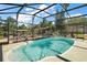 Inviting screened-in pool area surrounded by well-manicured landscaping at 28416 Tammi Dr, Tavares, FL 32778