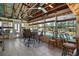 Enclosed sunroom with tile flooring, ceiling fans, dining table set, and views of the pool at 28416 Tammi Dr, Tavares, FL 32778