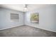 Cozy bedroom featuring gray carpet, light blue walls, and natural light streaming through windows with blinds at 331 W Lewis Ave, Apopka, FL 32712