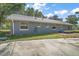 Side view of a one-story home featuring a gray exterior, light gray roof, and several windows at 331 W Lewis Ave, Apopka, FL 32712