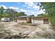 Exterior view of a wooden two-car garage with an adjacent gravel parking area and RV at 331 W Lewis Ave, Apopka, FL 32712