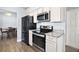 Well-lit kitchen features stainless steel appliances and a modern design at 331 W Lewis Ave, Apopka, FL 32712