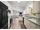 Open kitchen view with stainless steel appliances and a view to the living room at 331 W Lewis Ave, Apopka, FL 32712