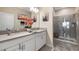Bright bathroom with double vanity, white cabinets, and glass enclosed walk-in shower at 3512 Belland Cir # B, Clermont, FL 34711