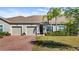 Charming home featuring a brick driveway, manicured lawn, and a welcoming entrance at 3512 Belland Cir # B, Clermont, FL 34711