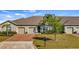 Attractive home exterior with brick driveway, lush lawn, and a neatly maintained landscape at 3512 Belland Cir # B, Clermont, FL 34711