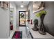 Inviting foyer with decorative vases, a console table, and a view of the front door at 3512 Belland Cir # B, Clermont, FL 34711