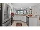 Bright kitchen features stainless steel appliances, white cabinetry, and seamless access to living area at 3512 Belland Cir # B, Clermont, FL 34711