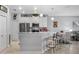 Contemporary kitchen featuring white cabinetry, a breakfast bar, and stainless steel appliances at 3512 Belland Cir # B, Clermont, FL 34711