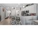 Lovely kitchen features white cabinets, stainless steel appliances, quartz countertops, and breakfast bar at 3512 Belland Cir # B, Clermont, FL 34711