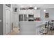 Kitchen boasts stainless steel appliances, pendant lighting, quartz countertops, and a cozy breakfast bar at 3512 Belland Cir # B, Clermont, FL 34711