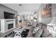 Open-concept living area with fireplace, gray sofa, adjacent to the dining and kitchen areas at 3512 Belland Cir # B, Clermont, FL 34711
