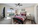 Main bedroom with tray ceiling, ceiling fan, large window, and stylish, comfortable furniture at 3512 Belland Cir # B, Clermont, FL 34711