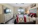Comfortable main bedroom features an attractive accent wall, large window, and stylish, comfortable furniture at 3512 Belland Cir # B, Clermont, FL 34711