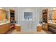 A bright bathroom with soaking tub, tile floors, and elegant fixtures at 3728 Mulberry Grove Loop, Leesburg, FL 34748