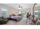 Comfortable bedroom with ceiling fan, large window, and carpeted floors at 3728 Mulberry Grove Loop, Leesburg, FL 34748