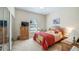 Cozy bedroom with carpeted floors, a comfortable bed, and a window providing natural light at 3728 Mulberry Grove Loop, Leesburg, FL 34748