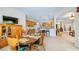 Dining area adjacent to kitchen with wooden table set, and open access to the kitchen and other living spaces at 3728 Mulberry Grove Loop, Leesburg, FL 34748