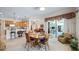 Dining area with wooden table set, with an open view of the kitchen and living room at 3728 Mulberry Grove Loop, Leesburg, FL 34748