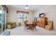 Bright dining room with wooden table and chairs set, and light colored walls and neutral carpet at 3728 Mulberry Grove Loop, Leesburg, FL 34748