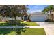 Charming home with lush lawn and brick driveway at 3728 Mulberry Grove Loop, Leesburg, FL 34748
