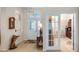 Entryway with decorative glass door, tile flooring, and decorative accent pieces and adjacent living space at 3728 Mulberry Grove Loop, Leesburg, FL 34748