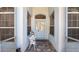 Inviting front entrance with chair and small table at 3728 Mulberry Grove Loop, Leesburg, FL 34748