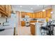 Spacious kitchen features light wood cabinets, white countertops, and a breakfast bar at 3728 Mulberry Grove Loop, Leesburg, FL 34748