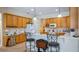 Well-lit kitchen with light wood cabinets, white countertops, and bar seating area at 3728 Mulberry Grove Loop, Leesburg, FL 34748