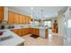 Bright kitchen featuring oak cabinets, tile floor, modern appliances and ample counter space at 3728 Mulberry Grove Loop, Leesburg, FL 34748