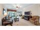 Open-concept living room with ample seating, a fireplace, and access to the outdoor screened in patio at 3728 Mulberry Grove Loop, Leesburg, FL 34748