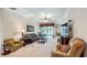 A spacious living room features comfortable seating, large windows, and neutral color palette at 3728 Mulberry Grove Loop, Leesburg, FL 34748
