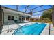 Inviting screened-in pool area with ceiling fan and furniture at 3728 Mulberry Grove Loop, Leesburg, FL 34748