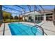 Beautiful turquoise screened-in pool with covered patio and sunny backyard at 3728 Mulberry Grove Loop, Leesburg, FL 34748