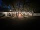 An outdoor entertainment area with string lights, mature trees, and a fire pit at 3860 Branch Ave, Mount Dora, FL 32757