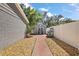 Backyard features a storage shed with a brick walkway, a white fence, and professional landscaping at 3860 Branch Ave, Mount Dora, FL 32757